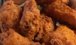 Close crop of buffalo wings with crisp browned skin